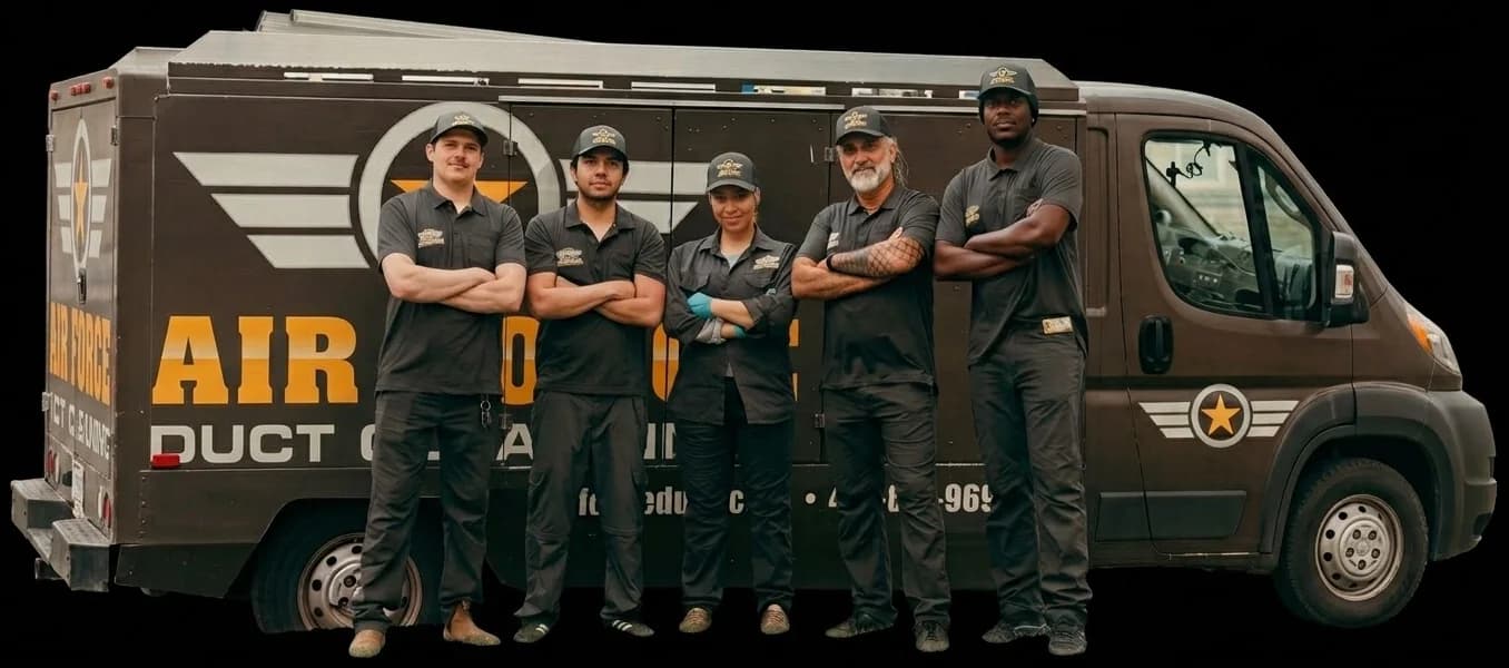The Air Force Shield crew, five technicians in uniform, beside their duct cleaning truck