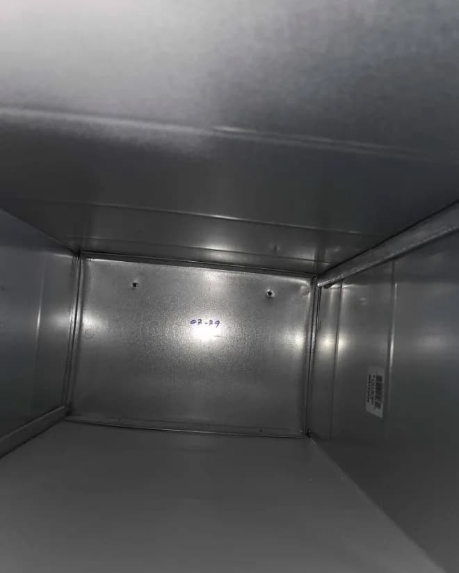 Inside an air duct after cleaning, down to bare metal
