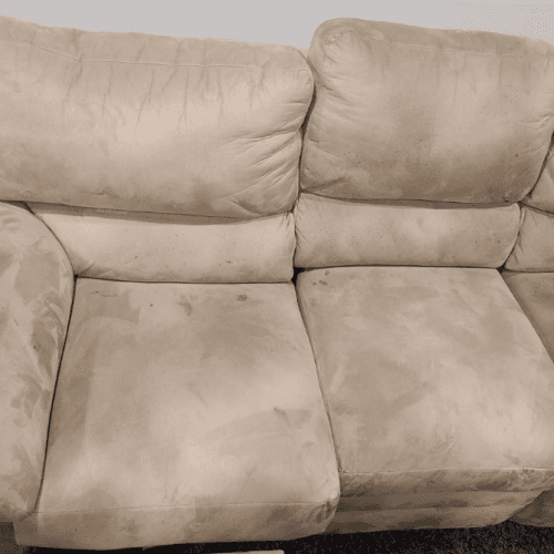 Beige loveseat with soiled cushions before cleaning